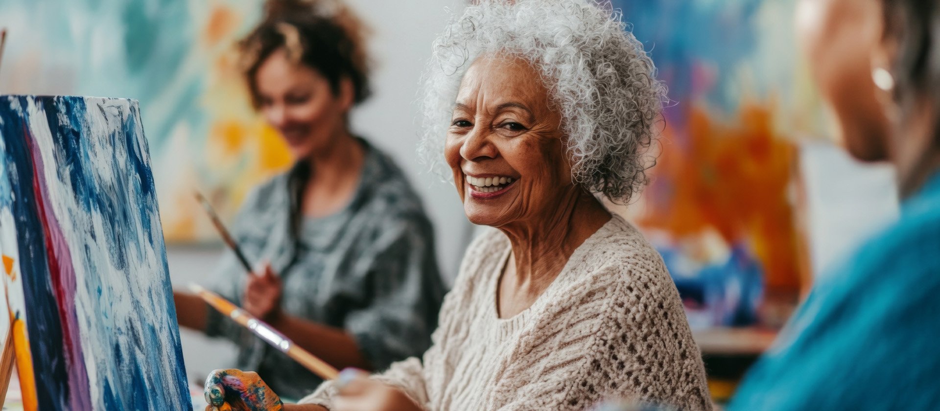 Senior living residents enjoying a painting class