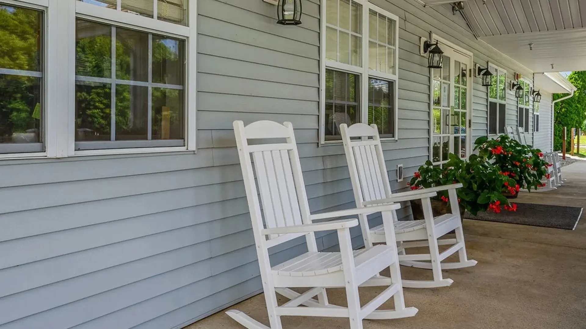 An inviting outdoor area at Cedar Creek of Logansport, showing lush green spaces and paved paths,