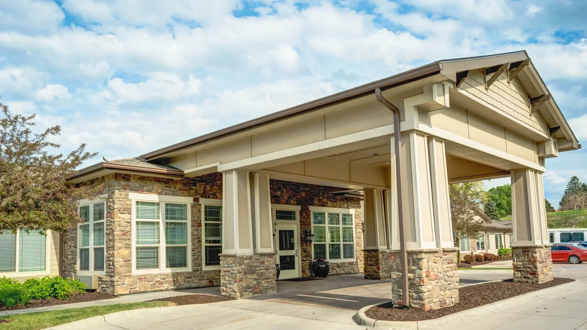 The welcoming front exterior of Cedar Creek of Prairie Meadows senior living community