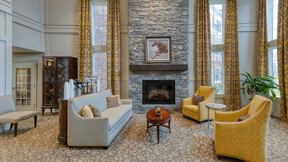 Cedarhurst of Beaumont's welcoming common area, complete with comfortable furniture and a warm fireplace for relaxation and socialization