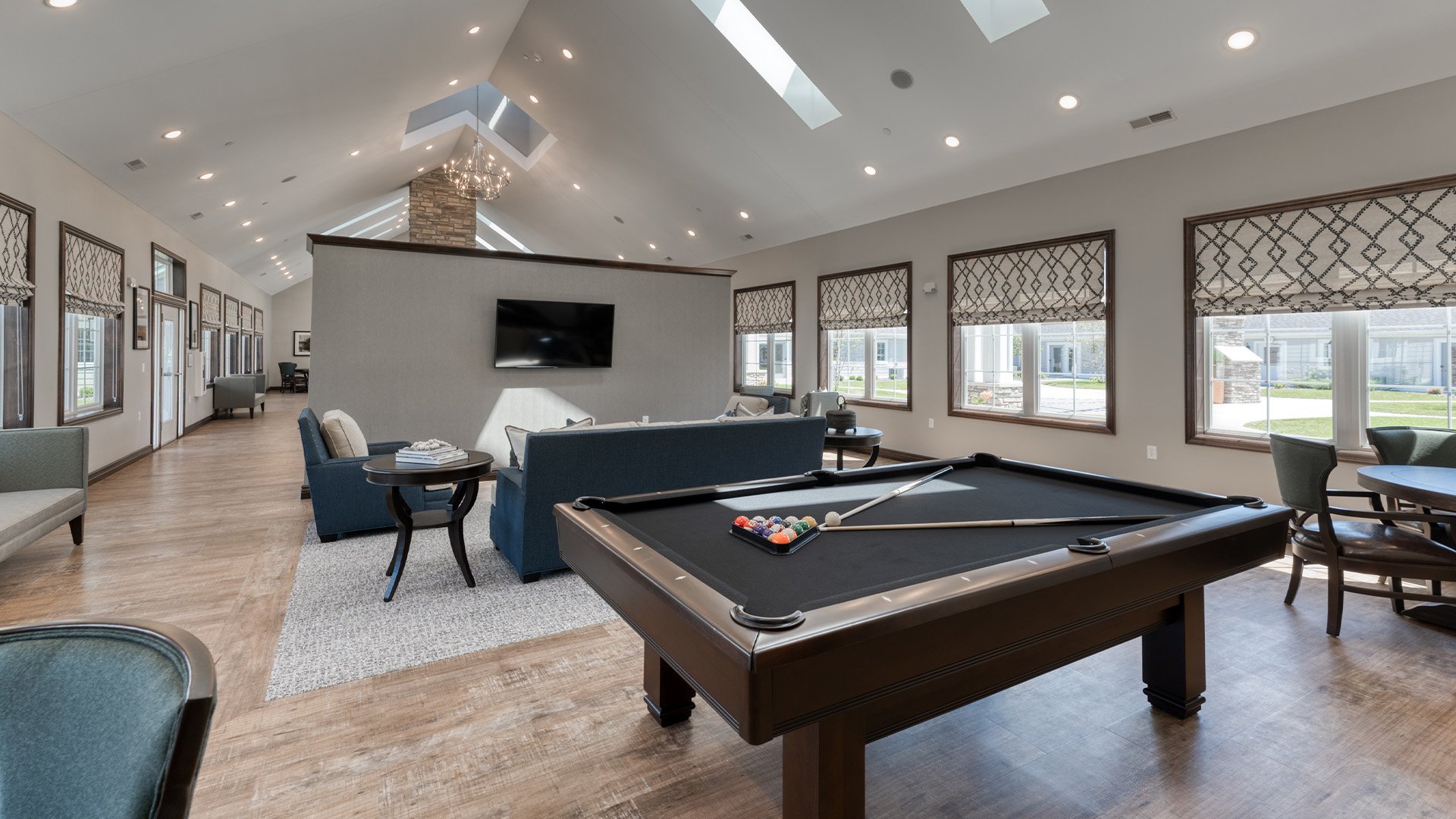 Well-equipped game room with a pool table at Cedarhurst of Farmington