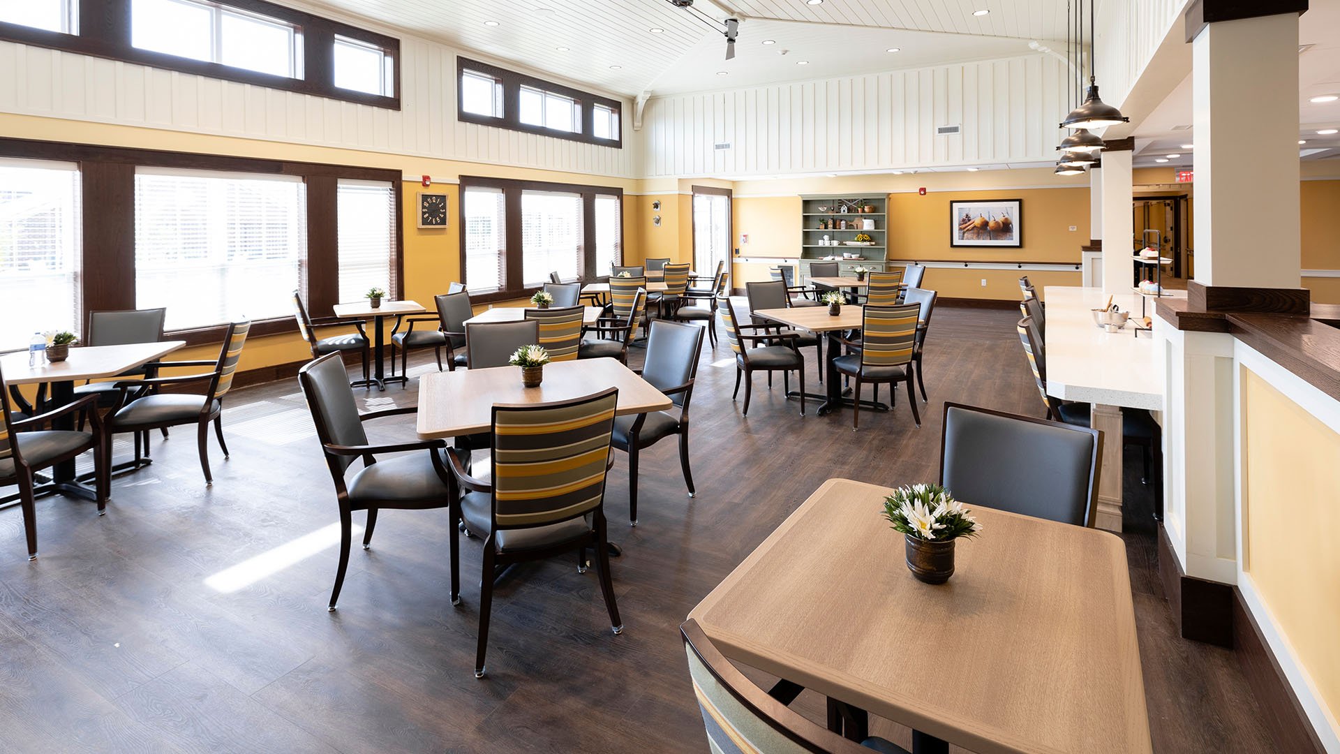 A spacious and bright dining room at Cedarhurst of La Vista, offering comfortable seating for meals