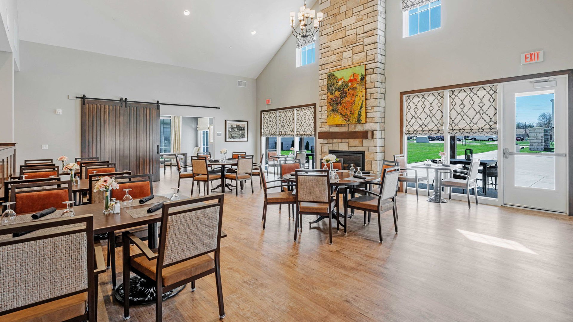 A spacious and bright dining room at Cedarhurst of Lawrence, offering comfortable seating for meals