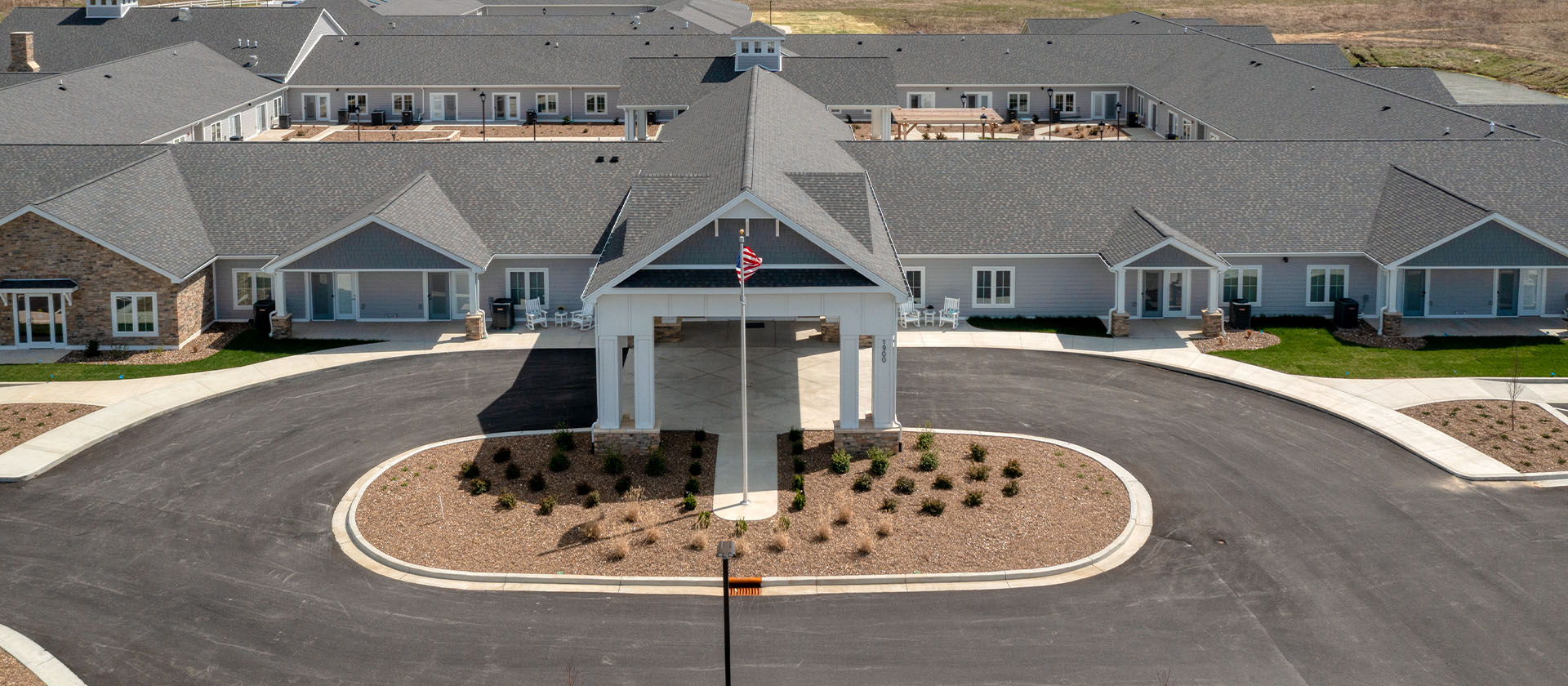An inviting view of the Cedarhurst of Owensboro senior living community from the outside, complete with the main building and its distinctive sign.