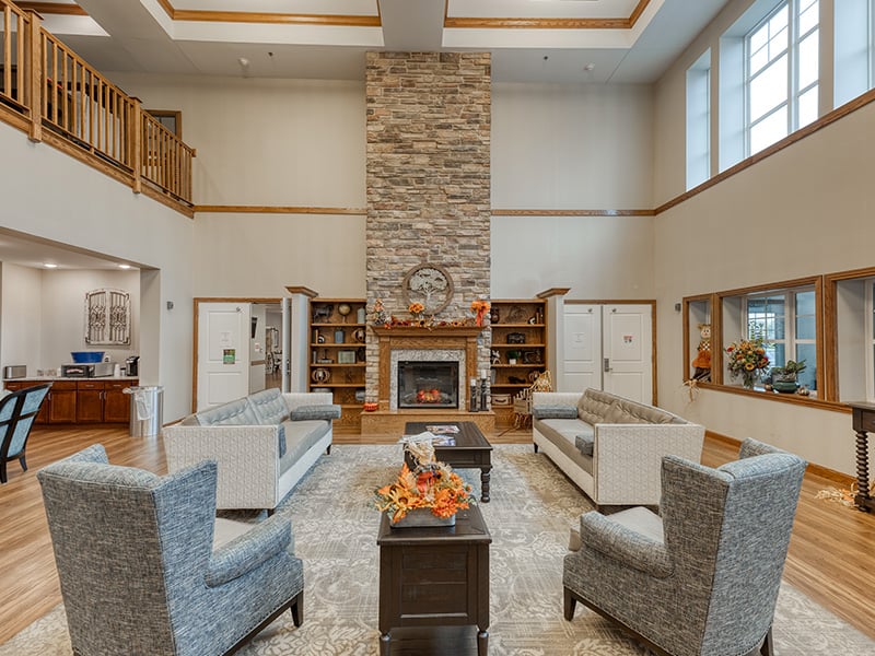 Cedarhurst of St. Charles's cozy common area, complete with a warm fireplace and comfortable seating