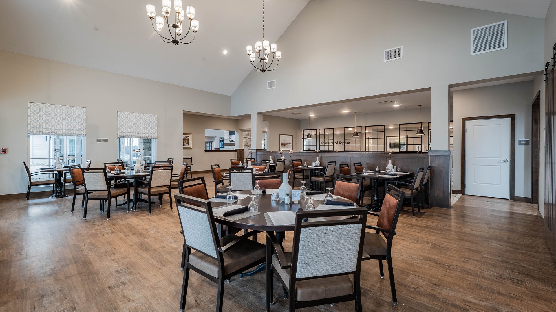 A spacious and bright dining room at Cedarhurst of Topeka, offering comfortable seating for meals