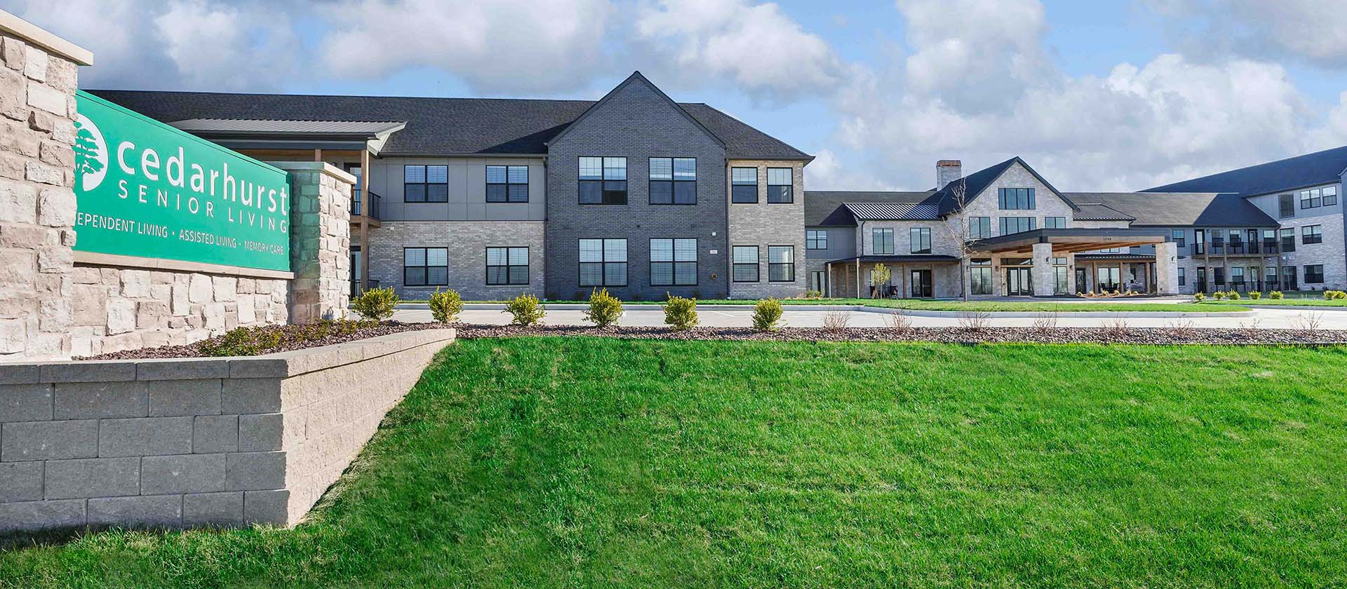 The welcoming exterior of Cedarhurst of Wentzville senior living community, with its prominent sign visible