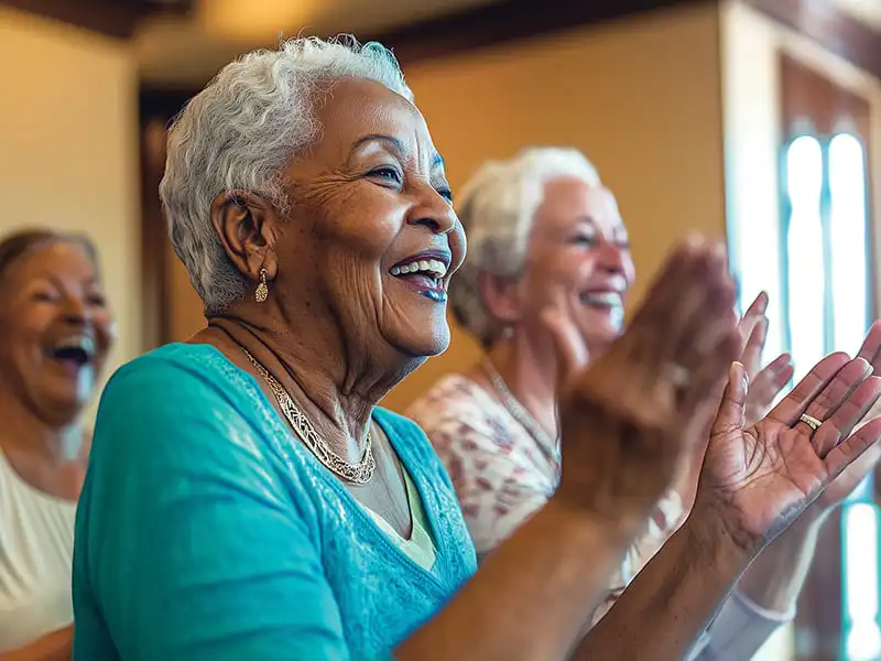 Independent living residents clapping and smiling
