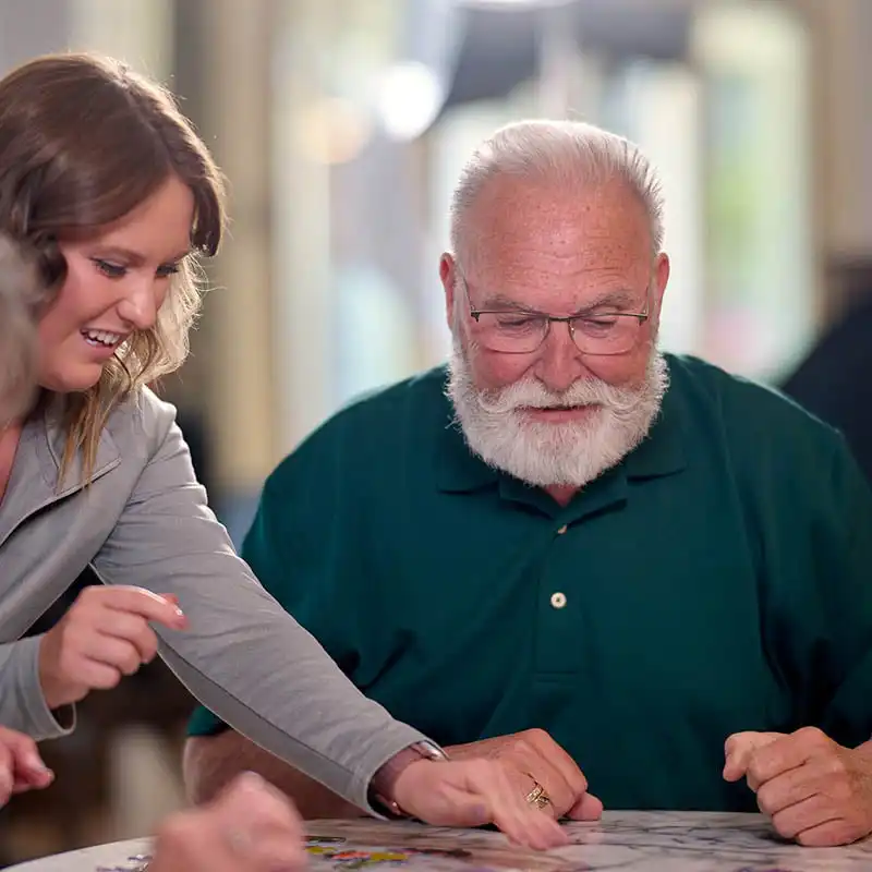 Senior living residents and Staff playing a game together