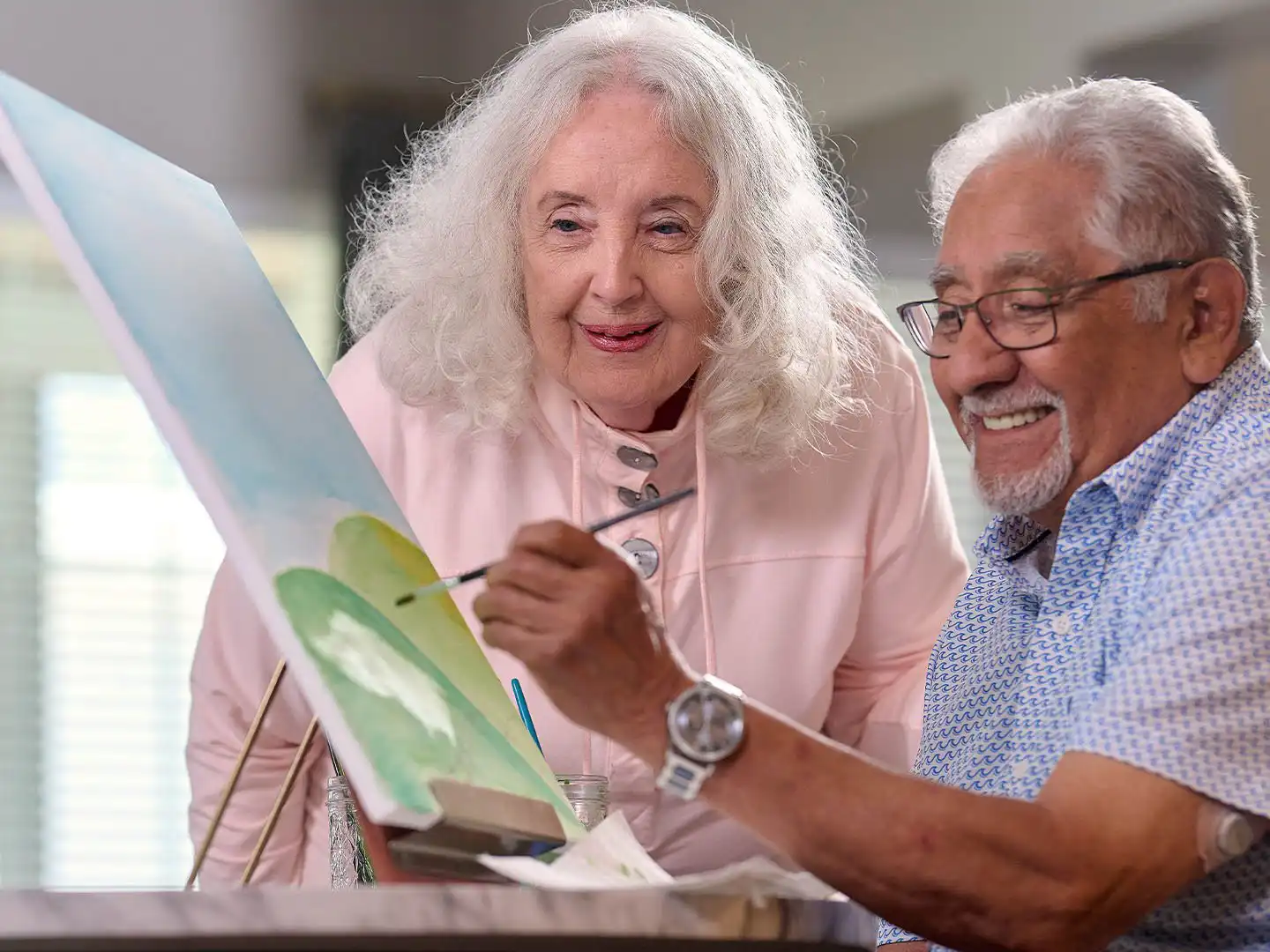 Senior living residents in painting class