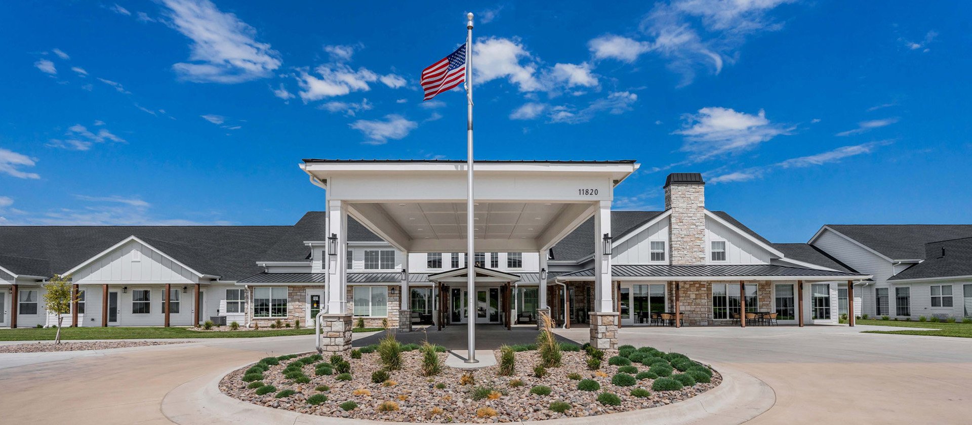 An inviting view of the Cedarhurst of Wichita senior living community from the outside, complete with the main building and its distinctive sign