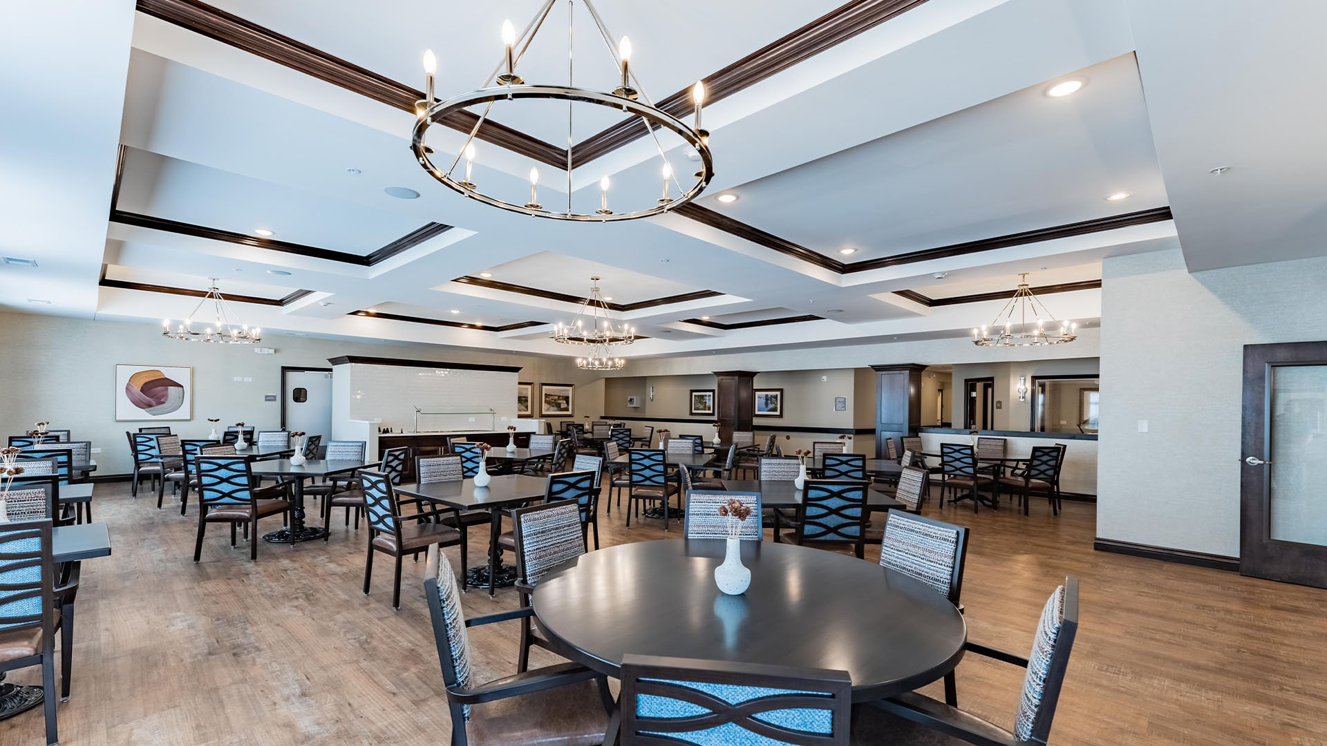 A spacious and bright dining room at Cedarhurst of Woodstock, offering comfortable seating for meals