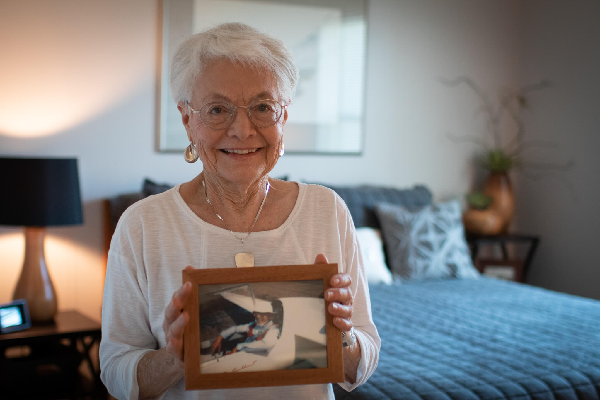 Shirley in her room holding a picture of her beloved husband Joe