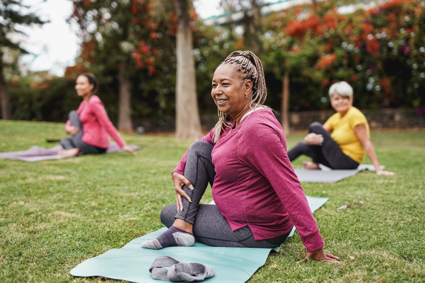 Multiracial women doing yoga exercise with social distance for coronavirus outbreak at park outdoor - Healthy lifestyle and sport concept-1308292203