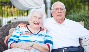Smiling Cedarhurst residents sitting outside together