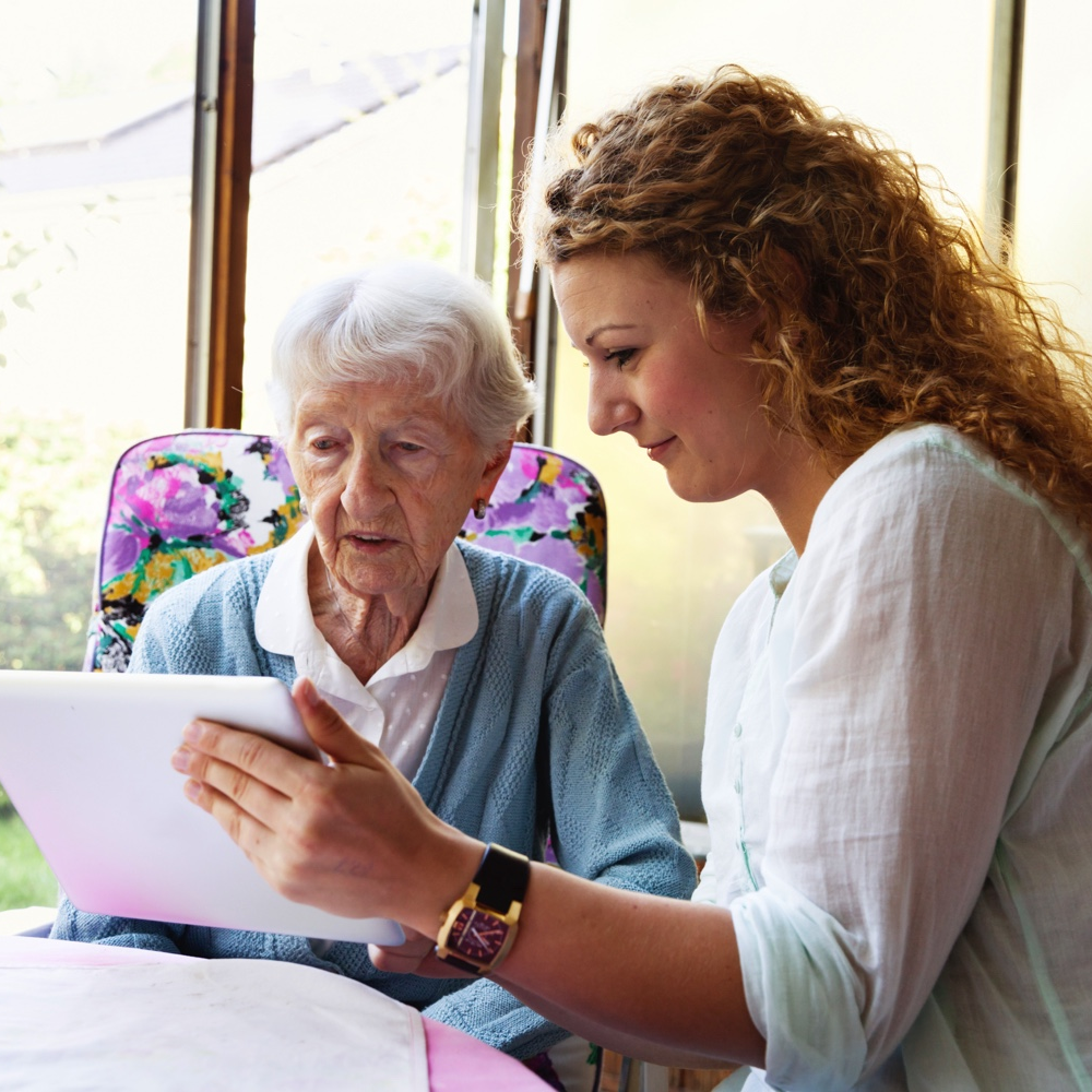 Woman holding tablet for senior
