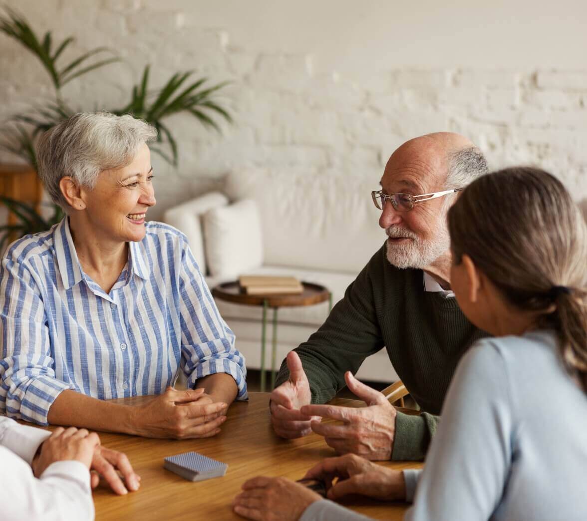 Senior living residents playing a card game