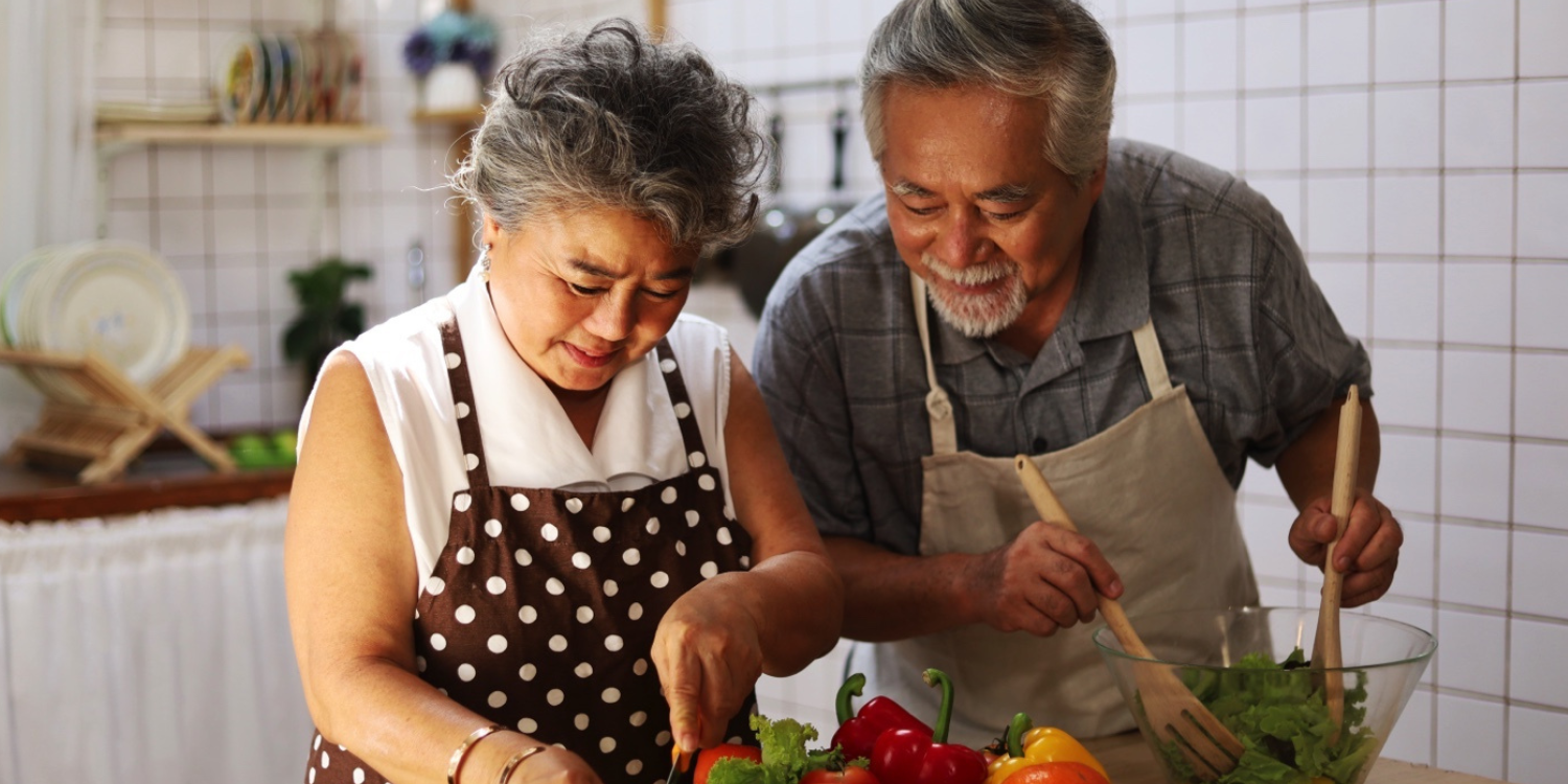 senior elderly couple having fun in kitchen