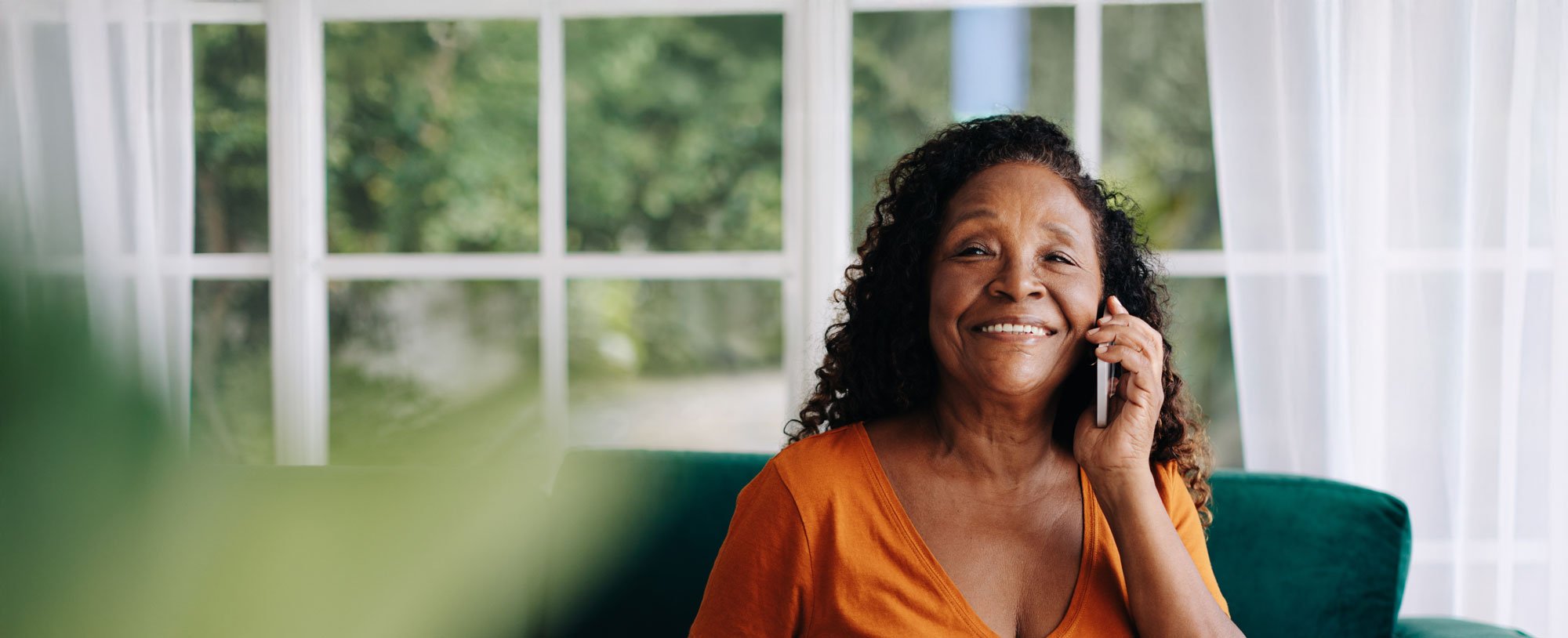 senior woman at home using computer and phone