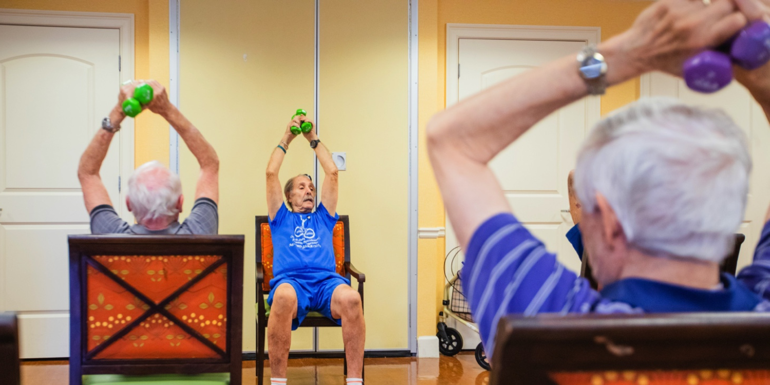 Seniors in a Cedarhurst Senior Living exercise class using weights which helps with bone strength in seniors.